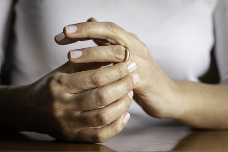 woman removing wedding ring