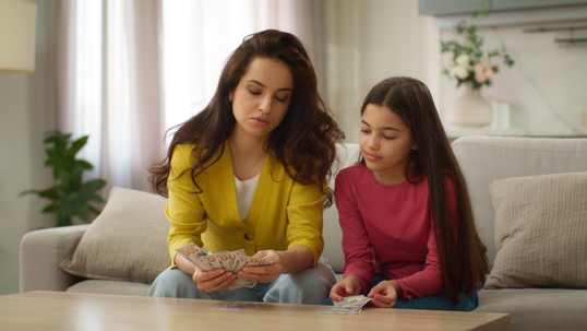 mother and daughter counting money