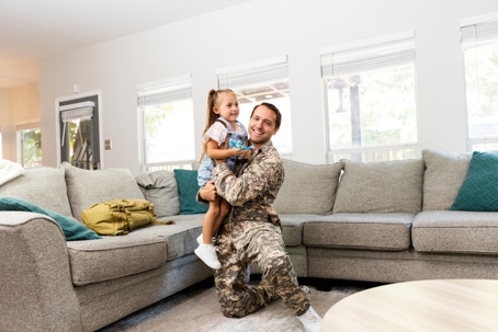 servicemember hugging child